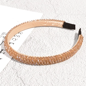 Detailed view of champagne beaded headband with sparkling multi-faceted crystals
