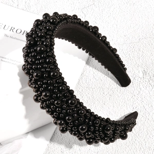 Detail of luxury padded headband featuring glossy black beads and velvet lining