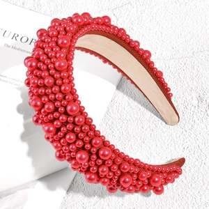 Detailed view of red padded headband with assorted pearls and non-slip inner fabric