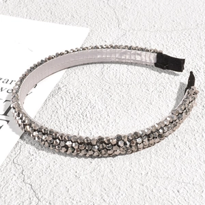 Close-up of sparkling silver rhinestone headband with detailed crystal embellishment