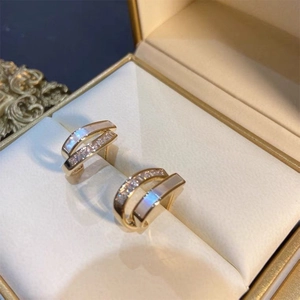 Elegant gold double-layered C-shaped hoop earrings with mother of pearl and zircons