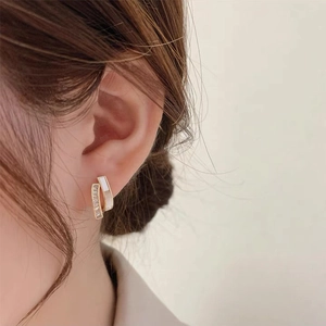 Elegant gold double-layered hoop earrings with white inlay and sparkling zircons
