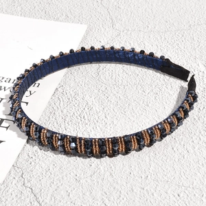 Macro detail of navy blue beaded headband with vintage style faceted crystals on fabric base