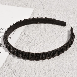 Close-up of black beaded headband with faceted stones and comfortable fabric end covers