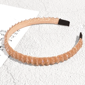 Detailed close-up of champagne beaded headband with non-slip texture and soft black tips