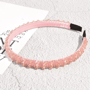 Detailed macro view of pink beaded headband with satin lining and anti-slip ends