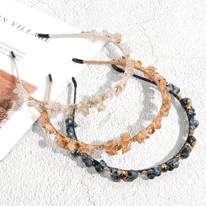 Baroque crystal headband set in champagne, clear, and navy blue with rhinestones