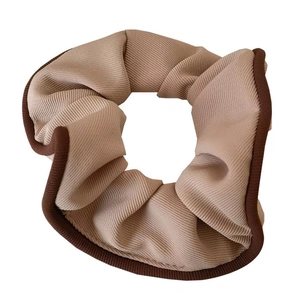 Elegant retro beige scrunchie with dark brown trim and soft ribbed texture for women