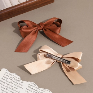 Elegant satin bow hair clips in brown and champagne gold with vintage metal duckbill style