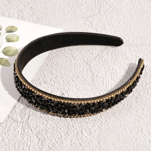 Detailed macro view of black crystal beaded baroque headband with gold rhinestone trim