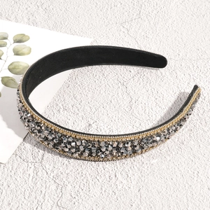 Macro detail of Baroque headband with sparkling grey rhinestones and gold chain trim