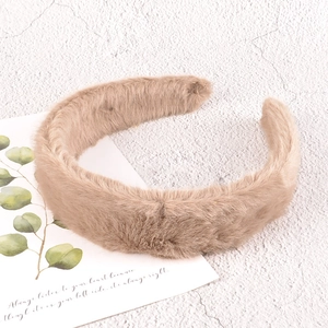 Detail view of thick light brown plush headband with soft fluffy faux fur texture