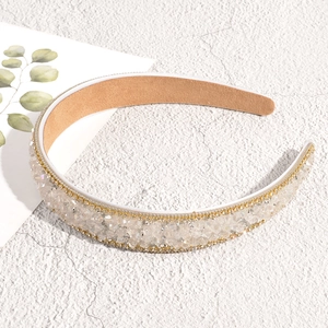 Detailed view of Baroque headband with sparkling rhinestones and gold beaded trim