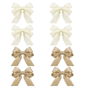 Detail of 8-piece satin bow hair clip set in cream and champagne silk fabric texture