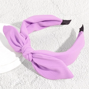 Detail showing the lavender fabric texture and stylish knotted bow on the wide headband
