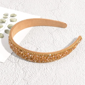 Close-up of baroque headband with champagne crystals and khaki suede lining details