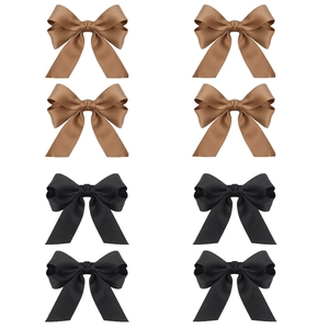 Detail view of 8-piece set featuring elegant satin bow hair clips in black and brown colors