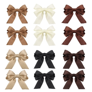 Detailed view of 12 bow hair clips in six classic colors with elegant satin textures