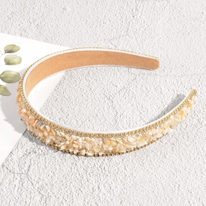 Close-up of handmade baroque headband with cream stones and double row rhinestones