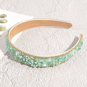 Detail view of Baroque headband with light green stone chips and sparkling rhinestones