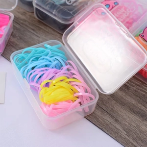 Colorful jelly-colored hair elastics set in a transparent storage box for daily styling