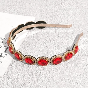 Baroque style gold headband featuring large red oval rhinestones and white accent crystals