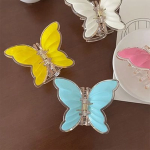 Set of four colorful butterfly hair claws in yellow, white, blue and pink candy colors