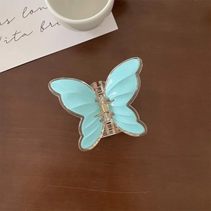 Detailed top view of light blue butterfly hair claw clip with transparent edges and gold spring