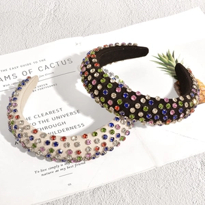 Close-up of sparkling colorful rhinestones on black and beige padded sponge headbands