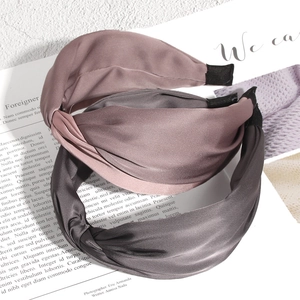 Elegant twisted satin headband for women in lotus pink and dark grey glossy fabric