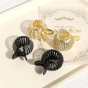 Detailed view of four rhinestone bird nest hair clips arranged on an elegant tray