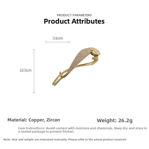 Detailed view of golden copper hair claw set with white zircons measuring 10.5cm by 3.6cm