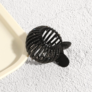 Detailed view of flexible black bird nest hair claw with rhinestones for high ponytail