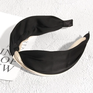 Elegant twisted wide satin headband in black and beige silk-like glossy fabric finish
