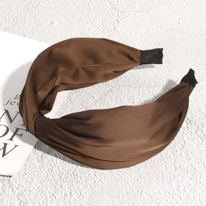 Detail showing the coffee brown satin cross knot headband with a smooth silk-like luster