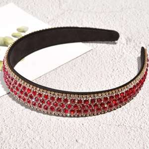 Macro detail of luxury wide headband with red and silver rhinestones on stone surface