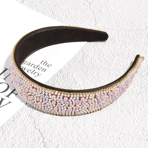 Detail of baroque headband with pink and white pearls and gold rhinestone trim