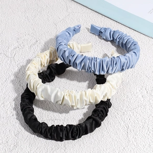 Elegant pleated satin headbands in blue, beige, and black with a glossy silk texture