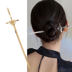 Detail of sword hair pins in gold and silver showing intricate hilt textures and styling