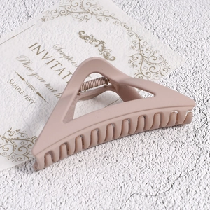 Matte nude triangle hair claw clip with minimalist hollow geometric design for women