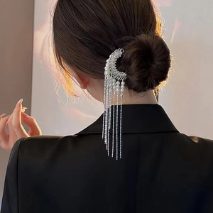 Elegant silver moon hair pin with long pearl tassels on a model's low bun hairstyle