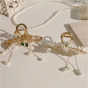Detail of lily of the valley hair claw clip with pearls and long tassel pendant