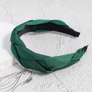 Detail of dark green braided headband showing 3-strand weave and non-slip inner lining