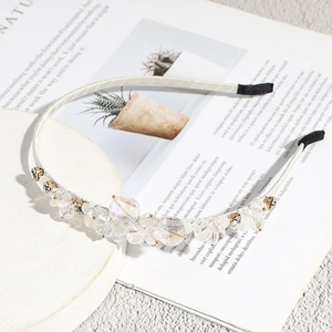 Elegant baroque headband with crystal beads and flowers on a white display stand