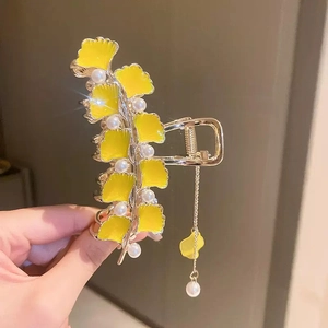 Elegant silver ginkgo leaf hair claw clip with yellow enamel and white pearls