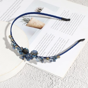 Detail of blue rhinestone headband with multi-faceted crystals on fabric wrap