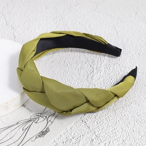 Close-up of olive green braided twist headband with elegant satin texture finish