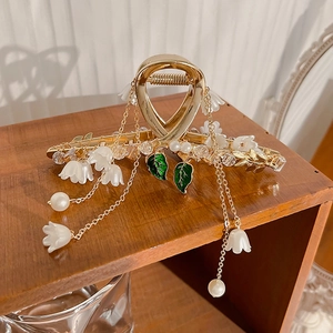 Elegant gold lily of the valley hair claw clip with pearls and long tassel chains