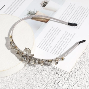 Close-up of elegant grey crystal beads and flower detail on a satin headband