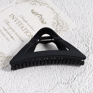 Detail of matte black triangular hair claw clip with strong spring and tight teeth